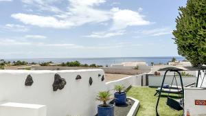 a white house with a view of the ocean at Very private luxury1 bed Casita 5 minutes walk to Marina in Puerto Calero