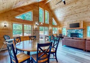 a dining room and living room with a table and chairs at Kingslanding Cabin in Carrabassett
