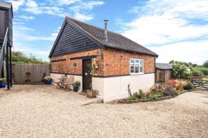 a brick house with a black roof at Pass the Keys Cosy Countryside Cottage in Tonbridge