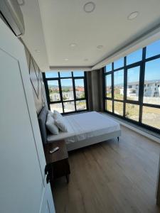 a large bedroom with a bed and large windows at Serim Residence in Kocaeli