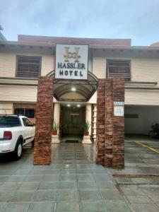 a hotel with a car parked in front of it at Hotel Hassler in Asuncion