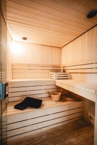 a sauna with a wooden floor and wooden shelves at Les Maritimes in Seignosse