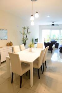 a dining room with a white table and chairs at BLUE OCEAN RIVIERA MAYA in Playa del Carmen