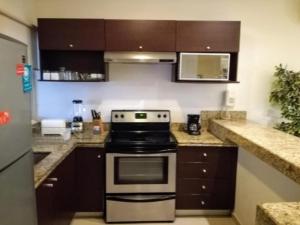 a kitchen with a stove top oven in a kitchen at BLUE OCEAN RIVIERA MAYA in Playa del Carmen