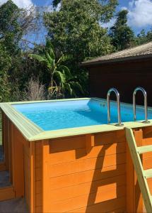 a swimming pool with two faucets on top of it at Bungalow Bois Exotique in Le Gosier