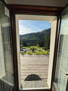 a glass door with a view of a patio at Chalet du Moléson in Gruyères