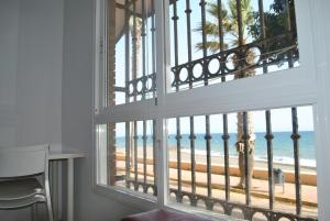 a room with a window with a view of the beach at Apartamentos la Caracola in Adra