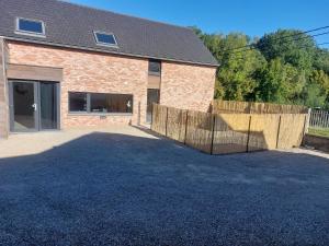 a brick building with a fence in front of it at Gite Comme chez soi in Spa