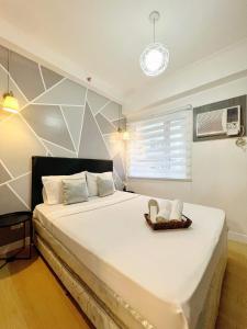 Postel nebo postele na pokoji v ubytování JA2 STAYCATION @TREES RESIDENCES