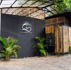 a black building with a sign on the side of it at Al Caribe Sur in Puerto Viejo
