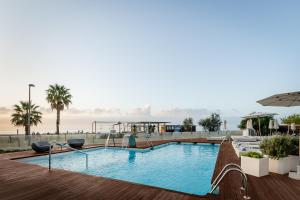 a swimming pool on the roof of a building at ALEGRIA Mar Mediterrania - Adults Only 4*Sup in Santa Susanna