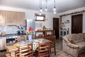 a kitchen and living room with a table and chairs at Un posto al sole - Caltanissetta in Caltanissetta