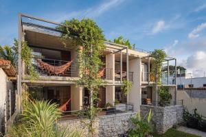 una vista exterior de una casa con plantas en Sensacional flat no Laguna Serena, en Pipa