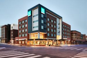 a building on a street with a crosswalk at AC Hotel by Marriott Oklahoma City Bricktown in Oklahoma City