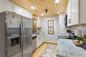 a kitchen with a stainless steel refrigerator and wooden ceilings at Ridgeview in Blowing Rock