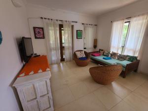a living room with a couch and a table at Riviera Hermitage Goa in Arpora