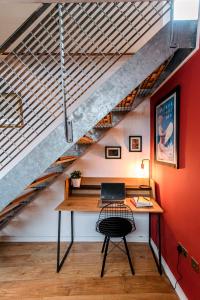 an office with a desk under a staircase at Unique, stylish and secluded home, with parking in the heart of historic York in York