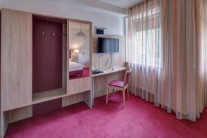 TV a/nebo společenská místnost v ubytování Hotel Leander