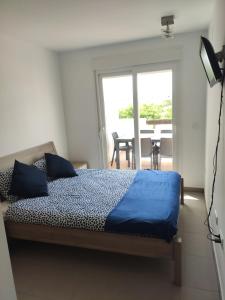 1 dormitorio con 1 cama y balcón con mesa en casa paradisiaca, en Murcia