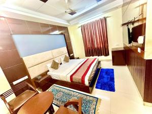 a small room with a bed and a table and chairs at Hotel Vista Inn, Karol Bagh, New Delhi - Near Metro in New Delhi