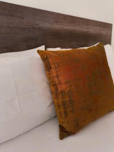 a pillow sitting on top of a bed at Olive Exclusive in Gaborone