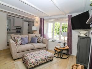 a living room with a couch and a tv at Hillside in Torpoint