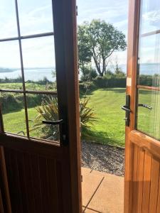 an open door with a view of a yard at Kesh Lakeside Cottage in Kesh