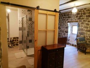 a bathroom with a shower and a glass door at Maison de charme à Saint-Andéol-de-Vals avec vue sur la montagne in Saint-Andéol-de-Vals +4 photos