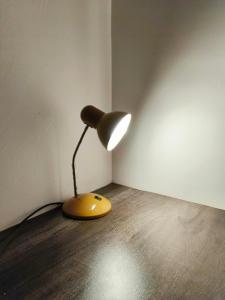 a yellow lamp sitting in the corner of a room at Olive Exclusive in Gaborone