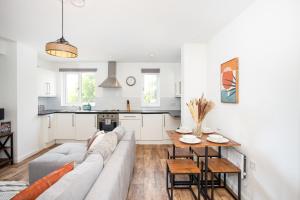 a living room with a couch and a table at Southend Serenity 2-Bedroom Flat - Southend Stays in Southend-on-Sea