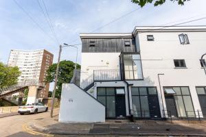 a white building with a staircase in front of it at Southend Serenity 2-Bedroom Flat - Southend Stays in Southend-on-Sea