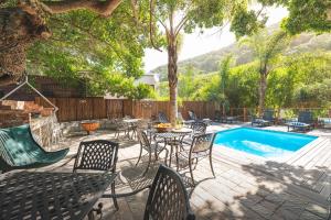 a patio with a table and chairs next to a pool at Thomasville in Wilderness