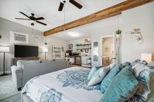 a bedroom with a large bed and a couch at PCB Beach House minutes from fun! in Panama City Beach