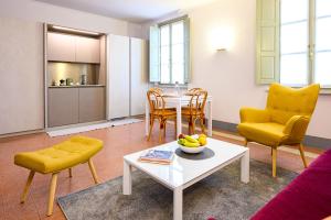 a living room with a couch and a table and chairs at Foresteria Villa Puccini Casa per Ferie-Holiday Home in Torre del Lago Puccini