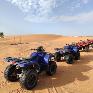 a group of four atvs in the desert at Berber & Camel Trek in Merzouga