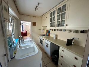a kitchen with a sink and a counter top at Beautiful Victorian house in central Cambridge in Cambridge +14 photos