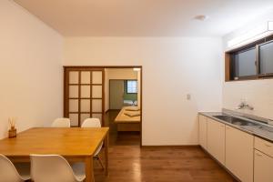 a kitchen and dining room with a table and chairs at sumica apartments in Nikko