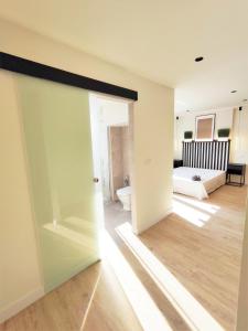 a room with a door open to a living room at Puertollano Central Park - by Pro Apartments - Free Parking in Puertollano