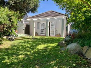 a small house with a gazebo in a yard at Anchor's Rest in Hermanus