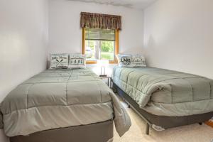 a bedroom with two beds and a window at Lakefront Marenisco Cabin with Private Dock! in Bergland
