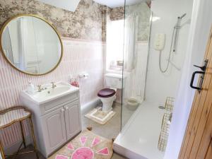 a bathroom with a sink and a shower and a mirror at The Waggon Shed in Nottingham