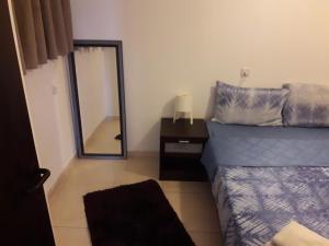 a bedroom with a bed and a mirror at tilis מרגולין 33 תל אביב in Tel Aviv