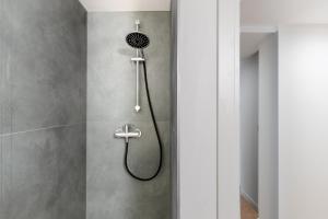 a shower with a shower head in a bathroom at Maison Revedin in Treviso