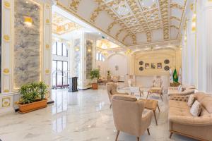 a large lobby with chairs and tables and a ceiling at Guest House Hotel Apartments in Yanbu