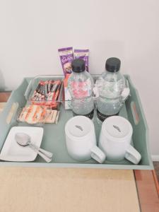 a tray with two bottles of water and cups at The Bosville Arms in Rudston