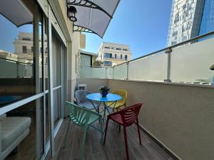 a balcony with a table and chairs on it at luxury 2 BD by dizingof near the beach in Tel Aviv