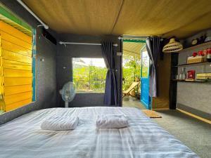 a bedroom with a bed with two pillows on it at Gió Homestay in Xuan An