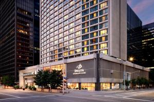 a large building with a sign on the side of it at Delta Hotels by Marriott Ottawa City Centre in Ottawa