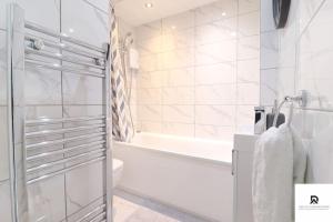 e bagno con doccia, vasca e servizi igienici. di Den Accommodation & Short Lets Greenwich London - 3 Bed House a Londra