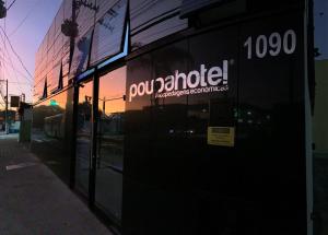 a building with a sign on the side of it at Poupahotel in Taubaté